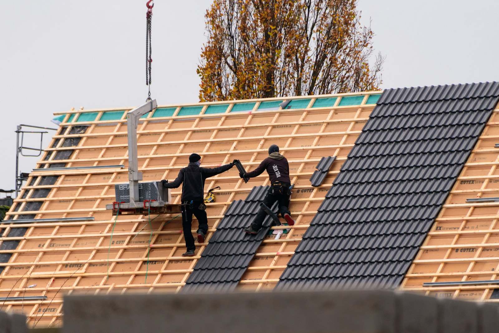 Dachdecker verlegen Ziegel auf einem Neubau